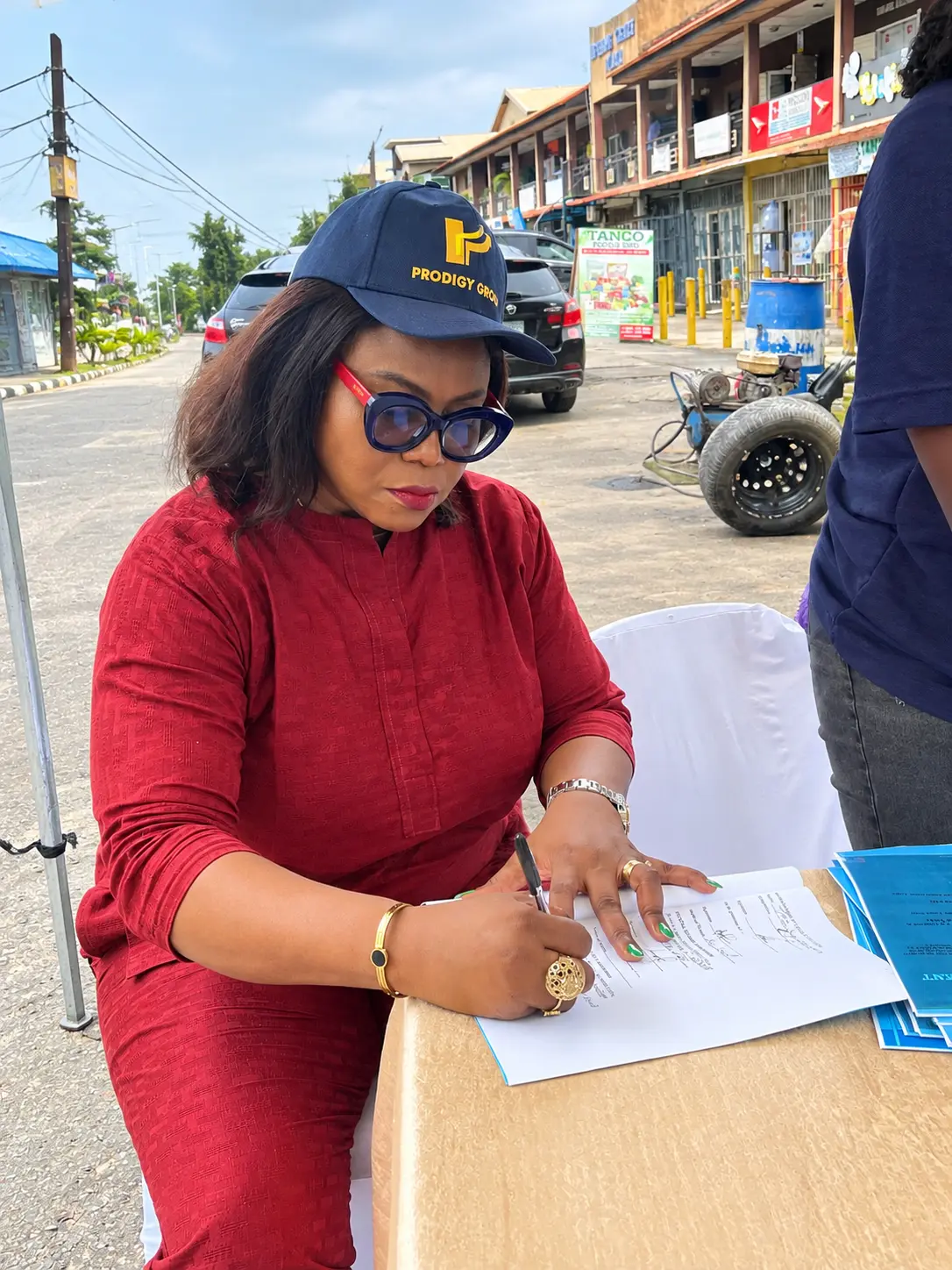 Attendee signing documents at the event table